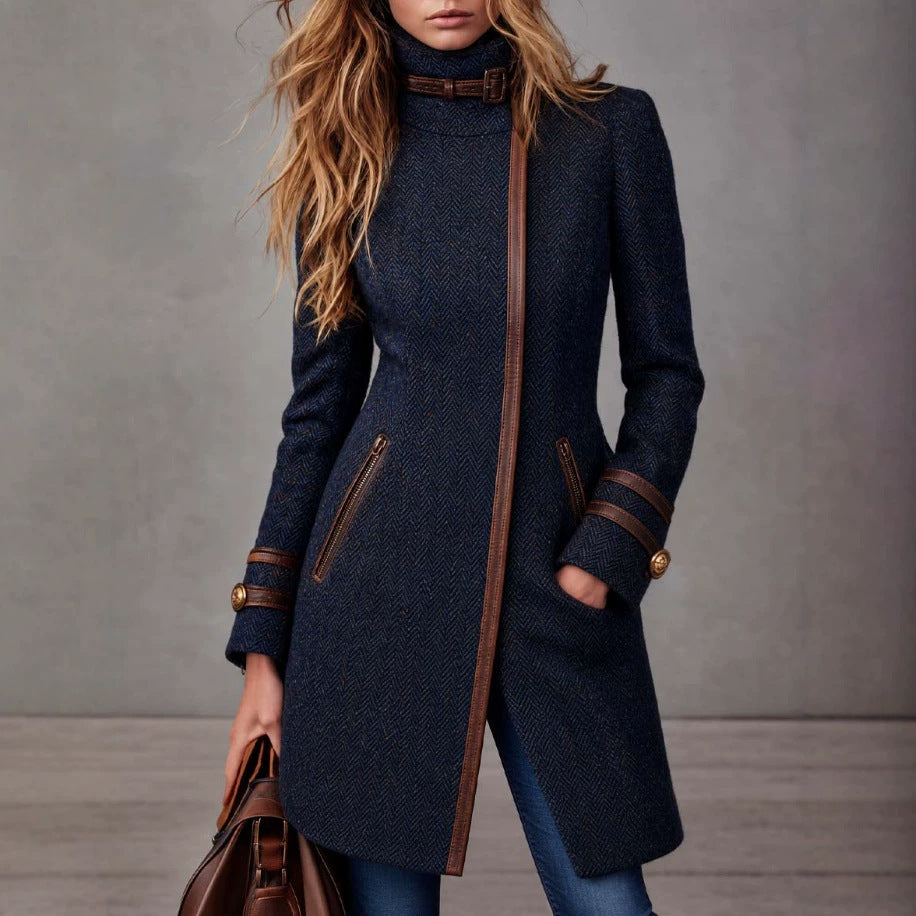 Mid-length navy herringbone tweed coat with side zipper, mock neck, and leather-trim pockets