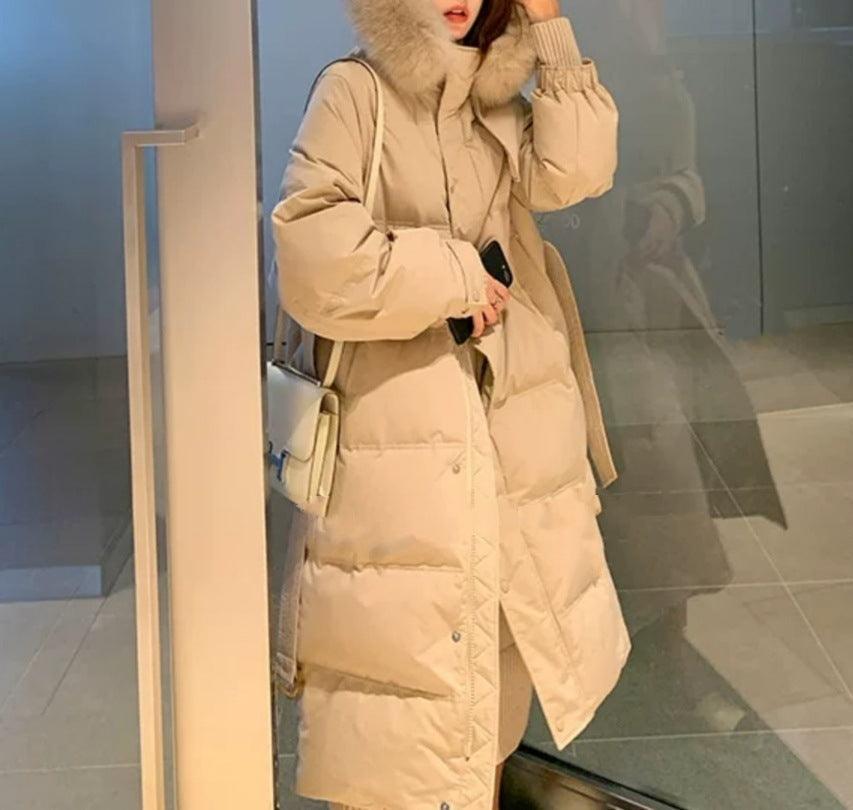 Mid-length down jacket in pale beige with faux-fur hood, button front, belted waist