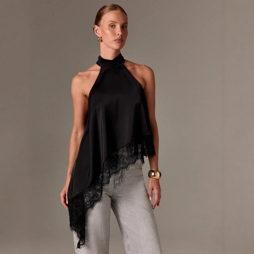 Black satin halterneck vest with asymmetrical drape and lace trim at the hem.