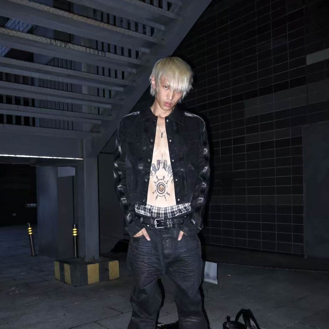 Black patchwork button-up jacket with collar and flap pockets, snap front details.