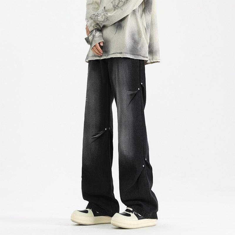 Black loose straight denim trousers with curved side pocket flaps and snap details