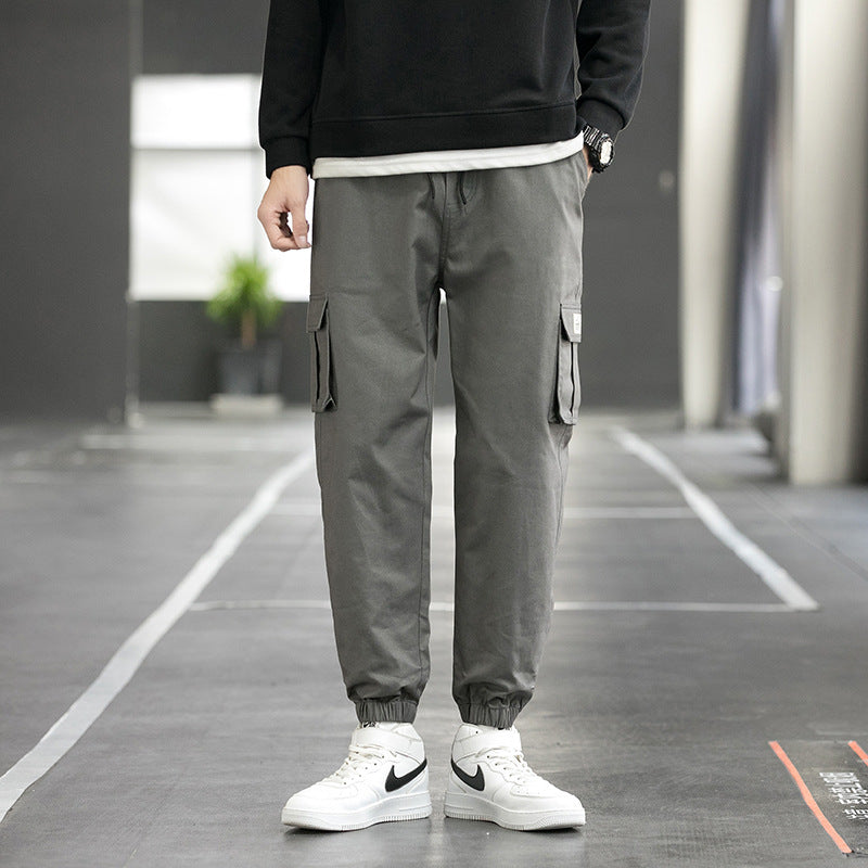 Men's grey cargo jogger pants with side cargo pockets and elastic ankle cuffs