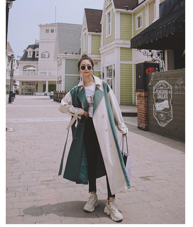 Long color-contrast trench coat, teal and cream panels, double-breasted with belt