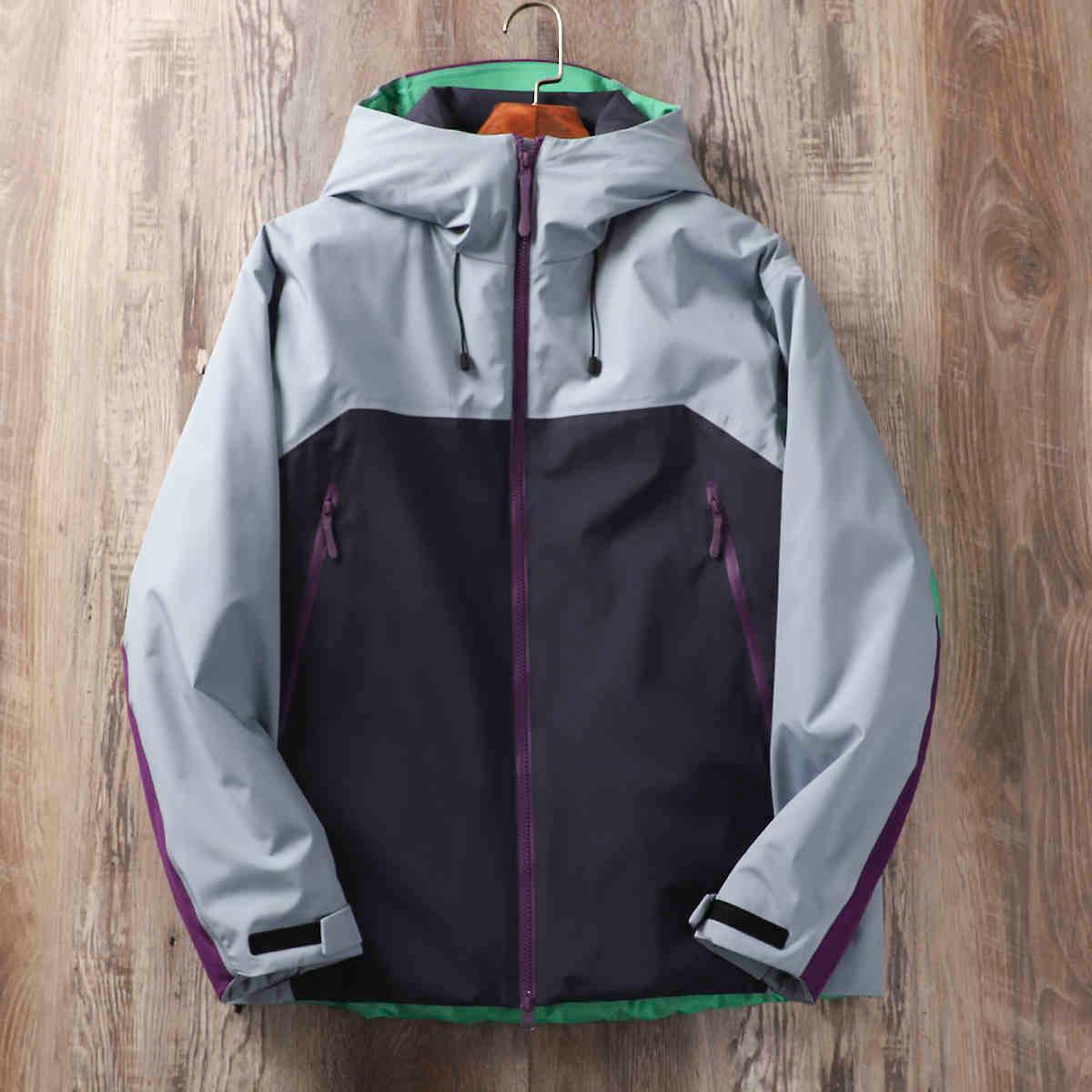 Hard shell jacket with hood, light gray and dark navy panels, purple zipper, green inner trim