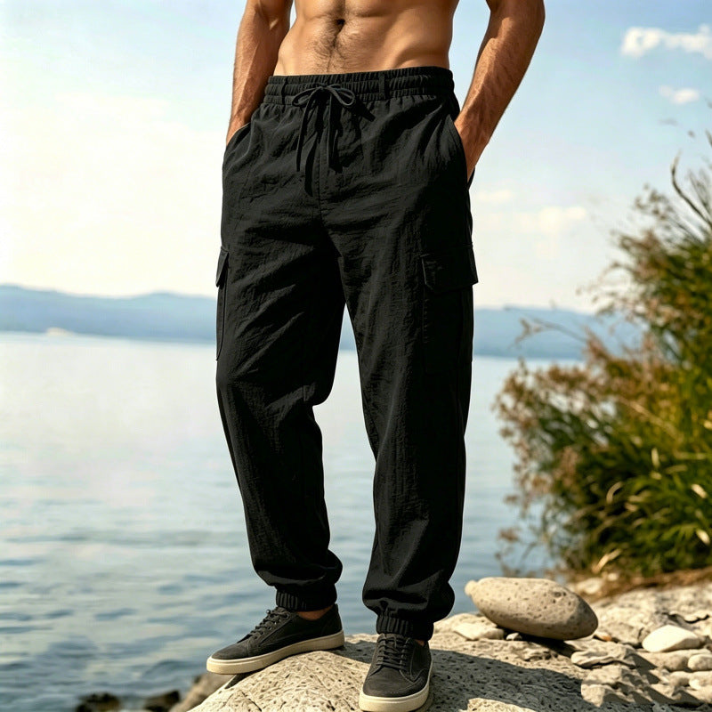 Black multi-pocket jogger pants with drawstring waist and cargo side pocket at leg