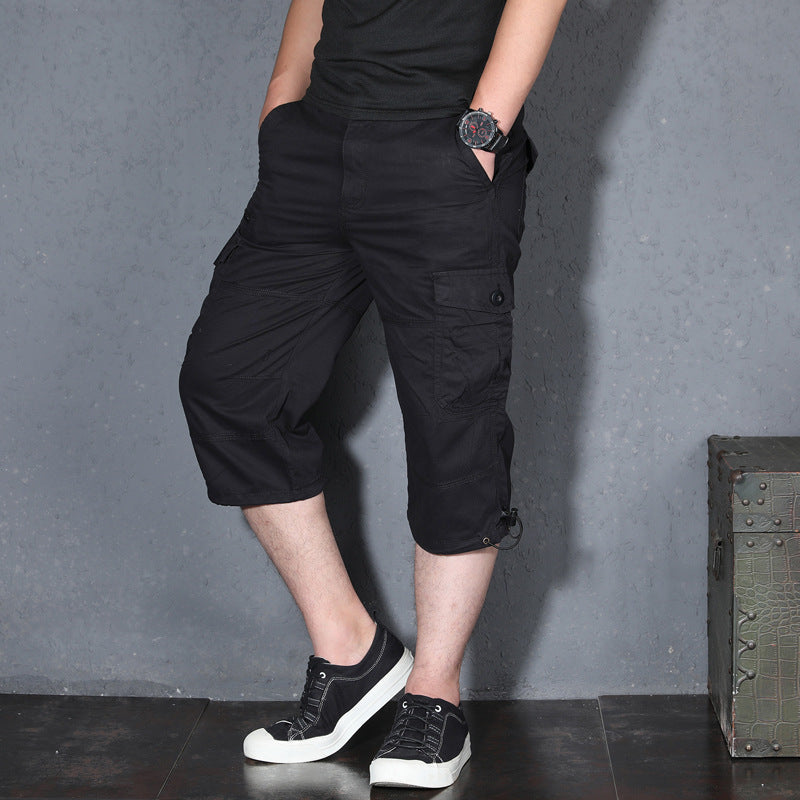 Men's black cargo shorts, loose knee-length fit with utility pockets and drawstring hem.