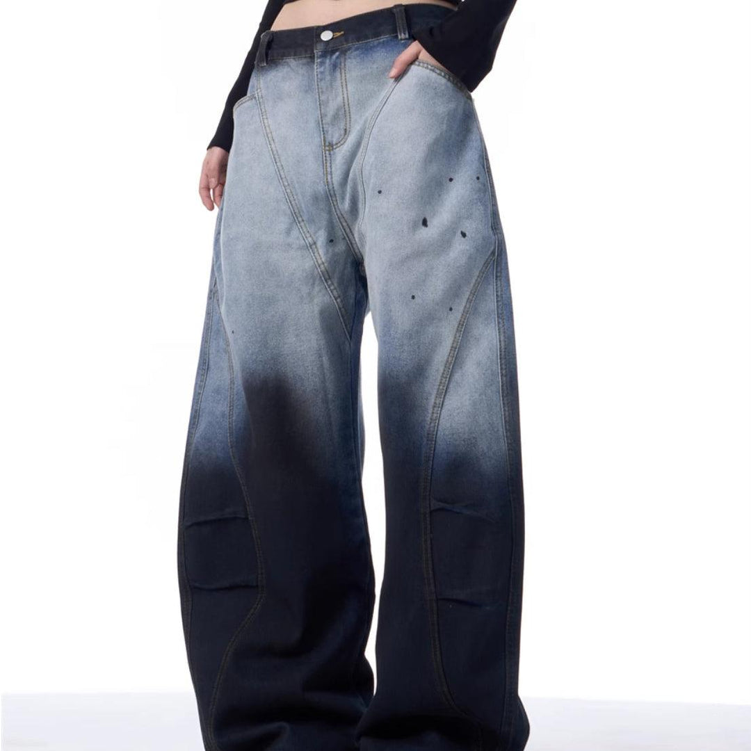 Women’s blue wide-leg jeans with dark patch panels and scattered speckle print