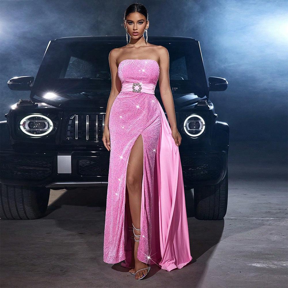 Pink strapless long gown with glitter bodice, cinched waist, and leg slit