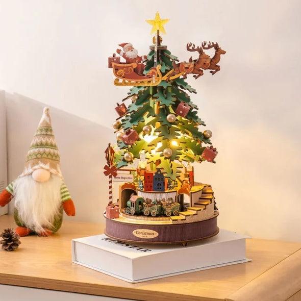 Wooden Christmas music box tree with lit green layers, star topper, Santa sleigh and reindeer