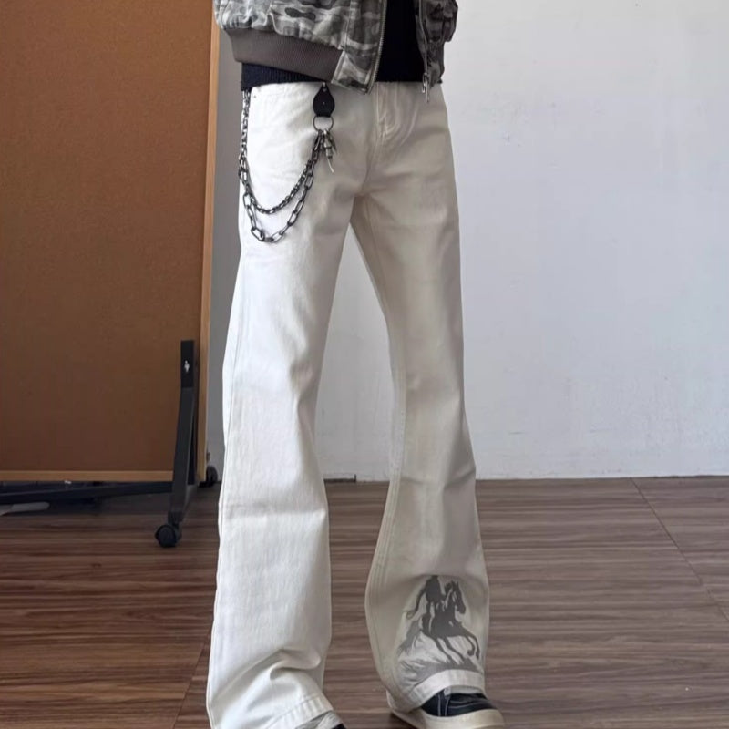White bootcut jeans with dark horse graphic embroidery on the leg and chained belt detail