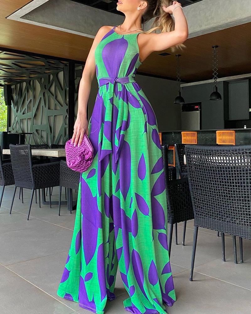Back/side view of purple and green printed sleeveless jumpsuit with lace-up waist, wide-leg maxi
