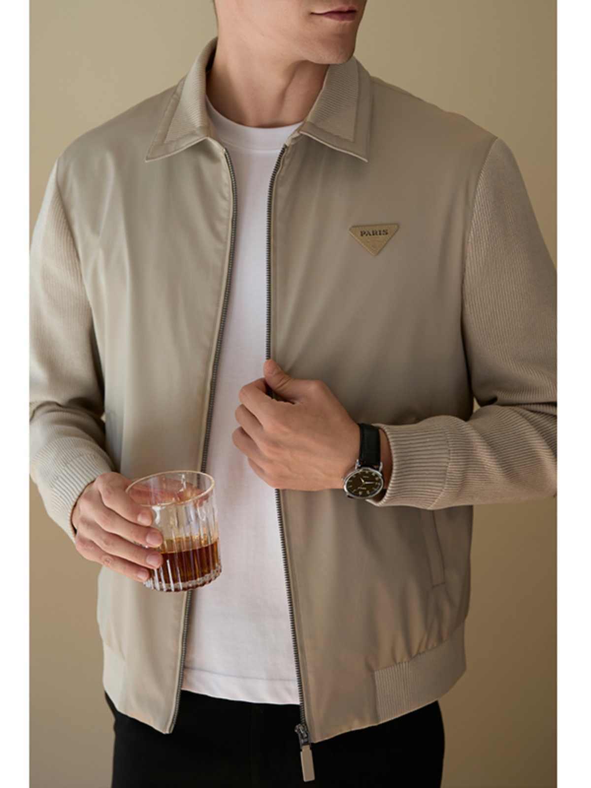 Beige men's zip-up jacket with stand collar, front pockets, and ribbed sleeve cuffs