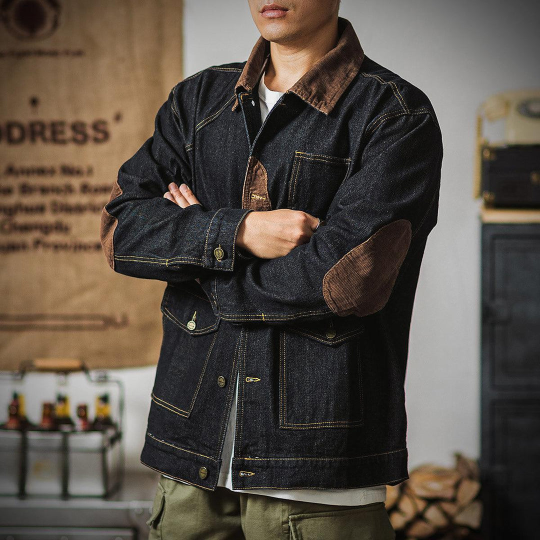 Black denim work jacket with brown collar, snap buttons, and chest flap pockets