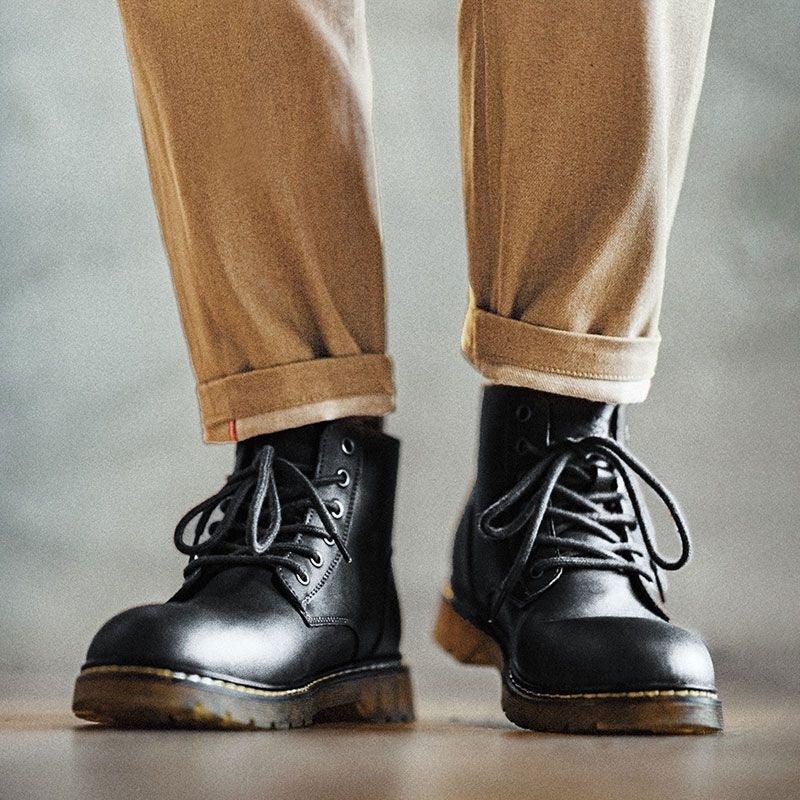 Black mid-top lace-up ankle boots with round toe and cushioned sole.