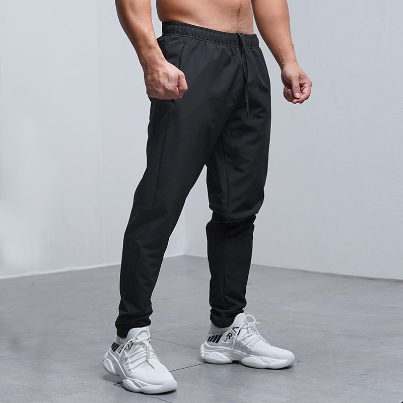 Men's black jogger sweatpants with elastic waistband and drawstring, tapered fit at ankles.