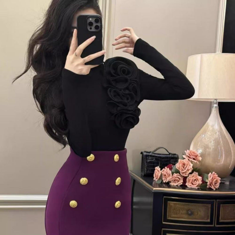 Black fitted turtleneck top with raised 3D rose appliques on front