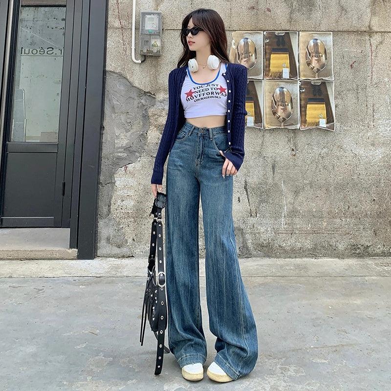 High-rise blue bell-bottom denim jeans with wide flared legs and front pockets