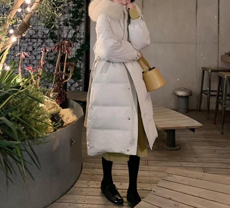 Mid-length down jacket in light cream with faux-fur hood, button front, belted waist