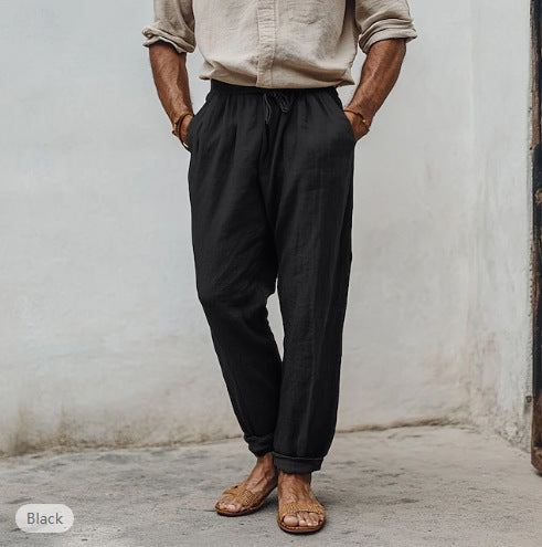 Men’s drawstring elastic-waist sports trousers, straight fit, solid black.