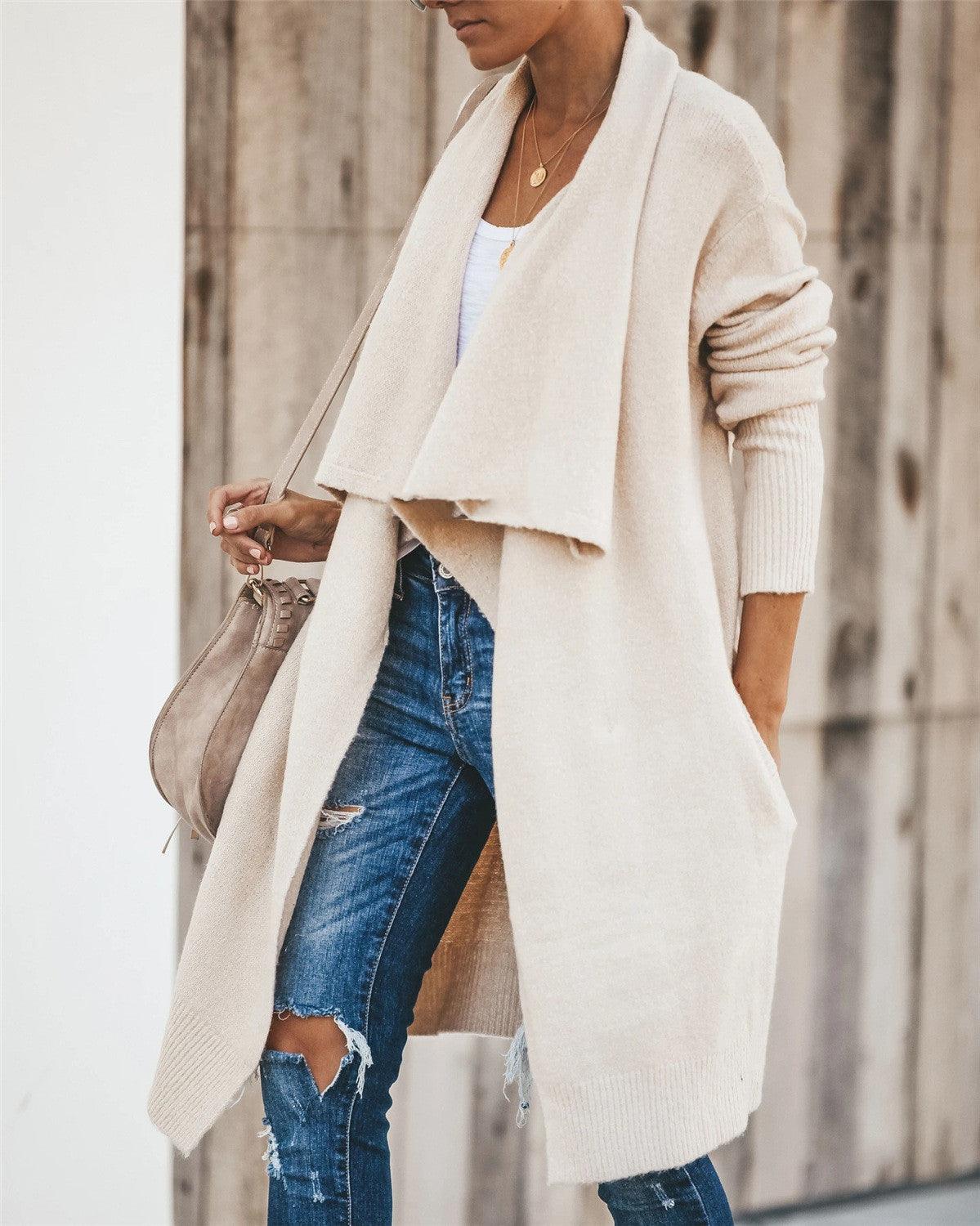 White knitted long coat with draped open front and cuffed sleeves