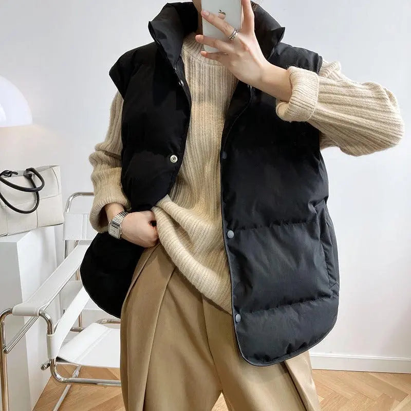 Black padded sleeveless puffer vest with button front and stand collar