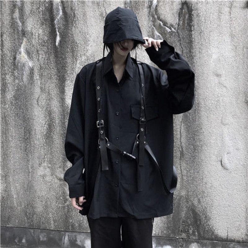 Black long-sleeve button-up shirt with chest pocket, layered straps and adjustable buckles
