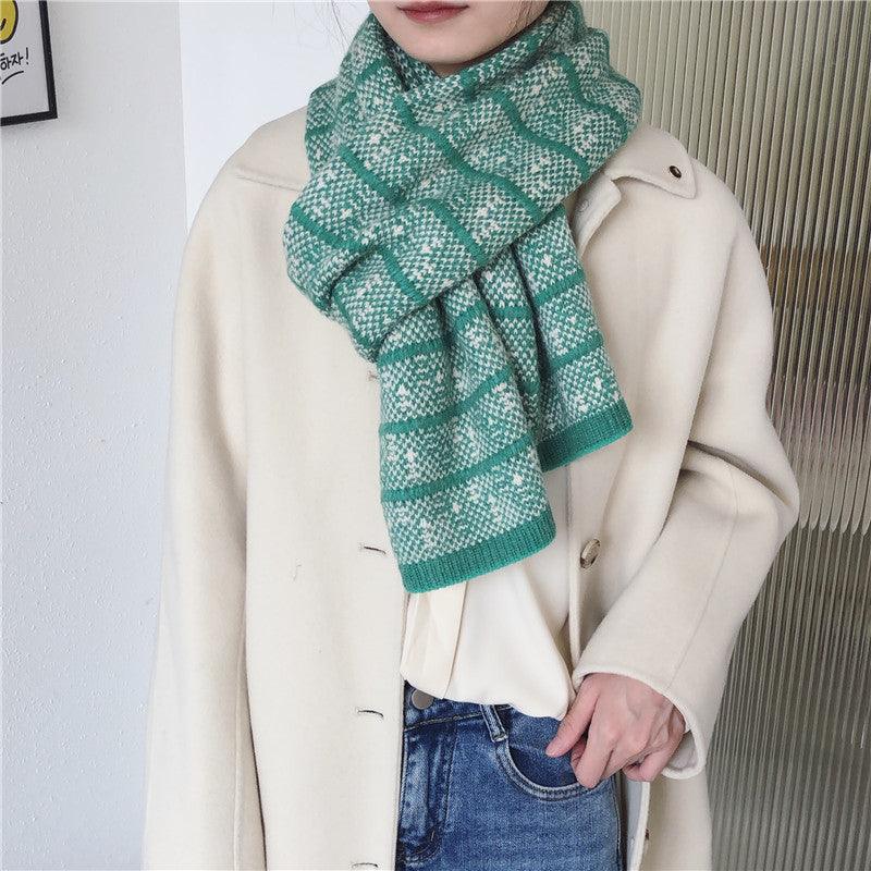 Woolen knitted scarf in green and teal striped jacquard pattern, draped