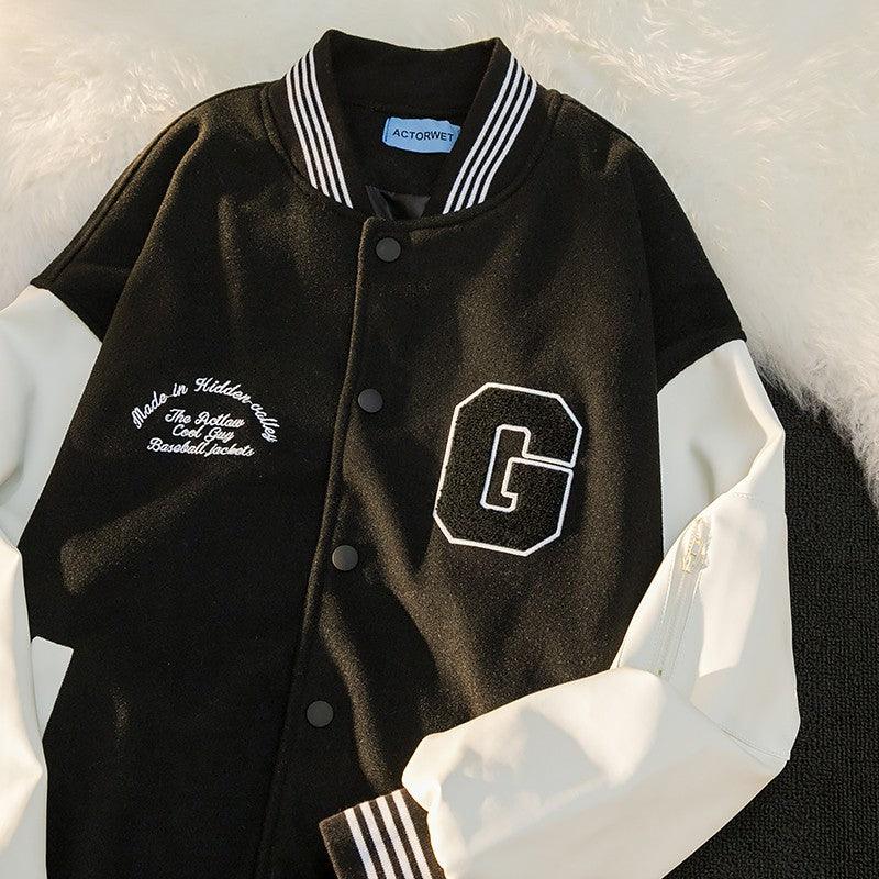 Black satin-look casual jacket with snap buttons, striped collar, and embroidered “G” patch