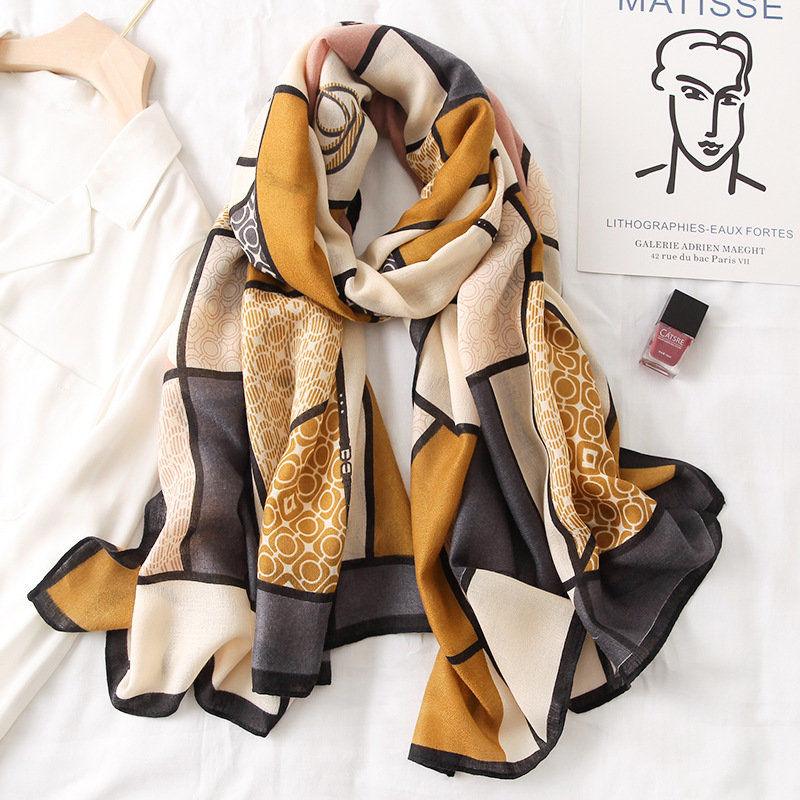 Silk scarf in black, cream, tan, and mustard with patchwork geometric print
