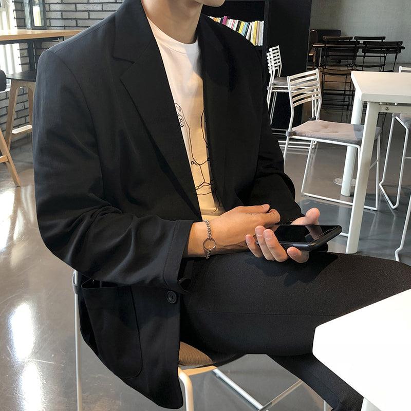 Loose casual single-breasted blazer jacket, dark black, notch lapels and front buttons.