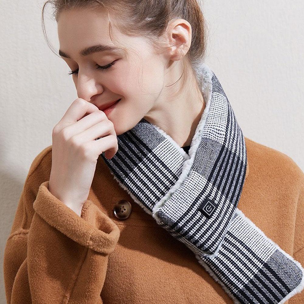 Black-and-white plaid smart heating scarf worn by person with small square logo