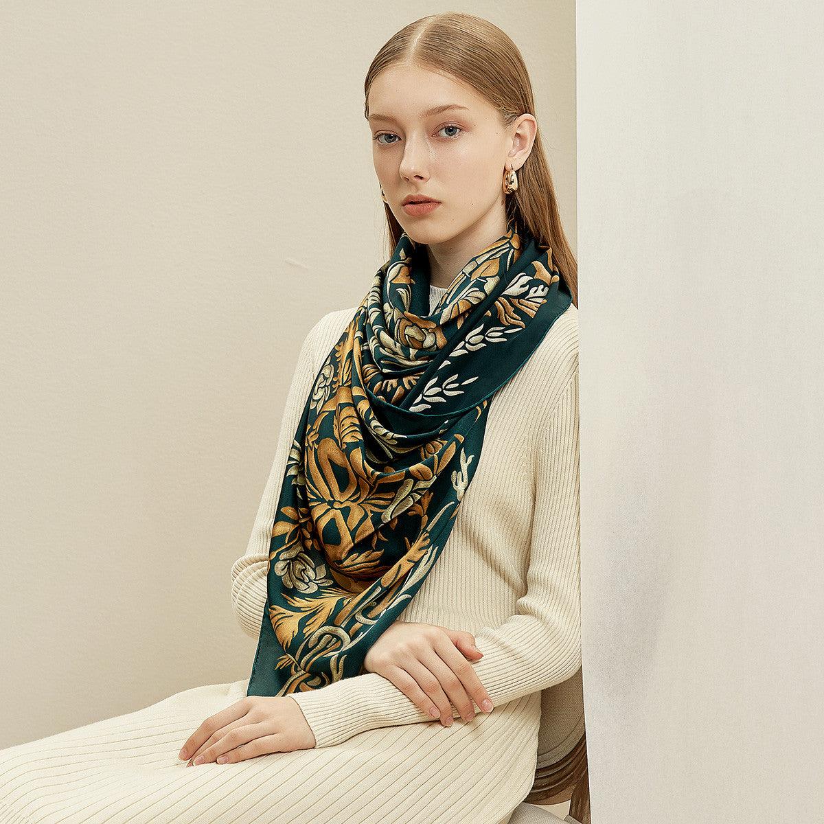 Silk scarf in deep teal with gold and ornate butterfly-like pattern, long ends