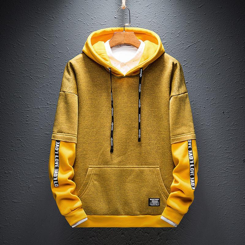 Boys yellow pullover hoodie with drawstring hood, kangaroo pocket, and printed sleeve bands