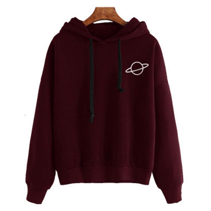 Wine red pullover hoodie with hood, drawstrings, front pocket, and small planet graphic