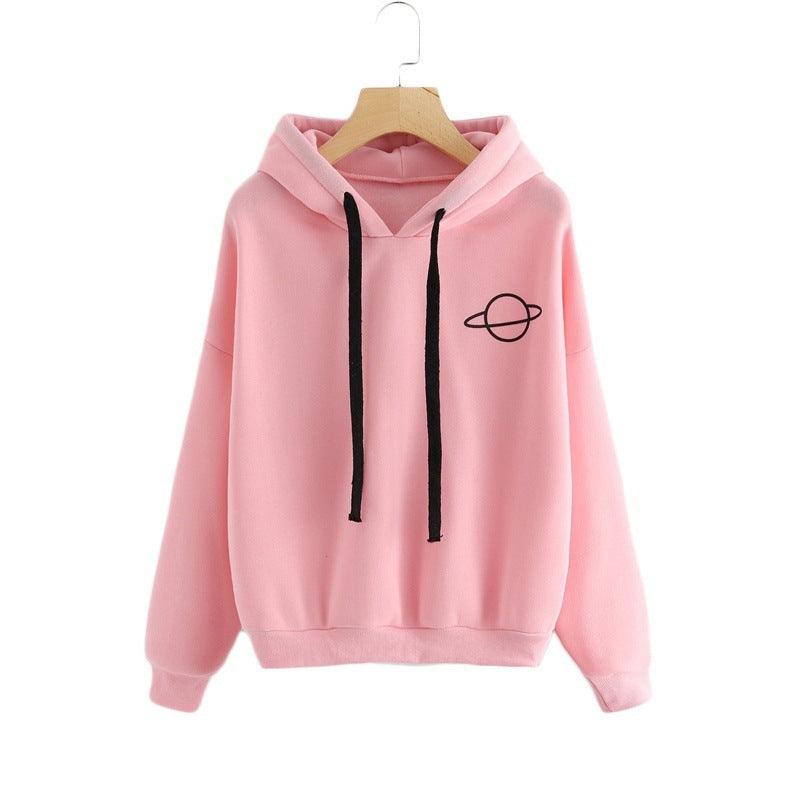 Light pink pullover hoodie with hood, black drawstrings, front pocket, and planet emblem