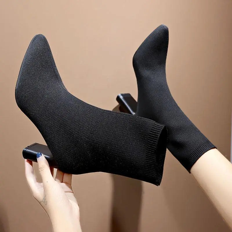 Black knit ankle boots with thick block heel and pull-on sock cuff