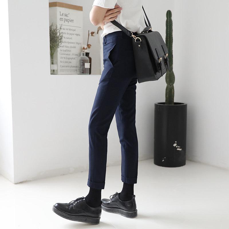 Navy straight-leg pants with slim straight fit and ankle cuffs