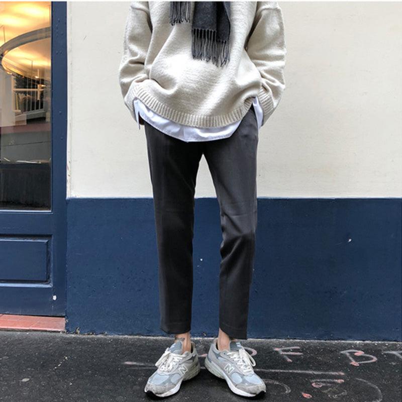 Dark straight-leg pants with cuffed hem and front pockets