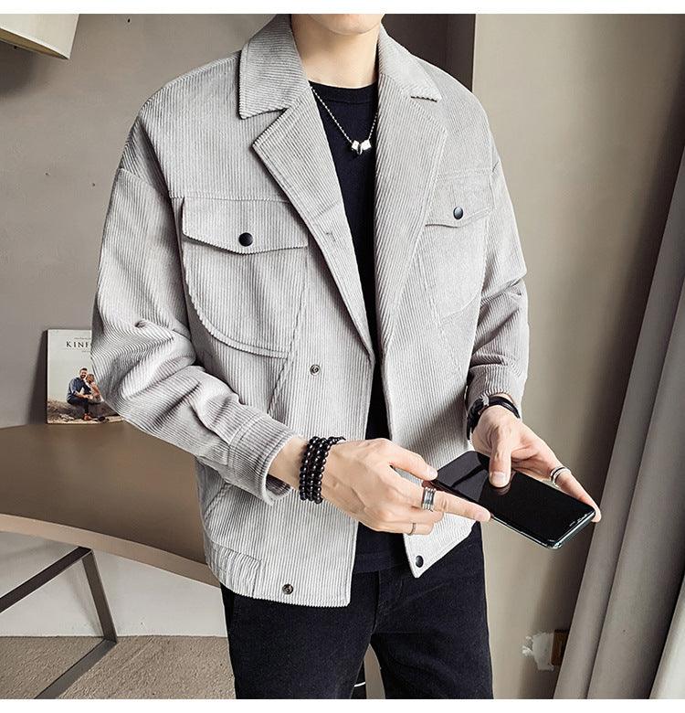 Light grey corduroy jacket with button front, chest flap pockets, and classic collar.