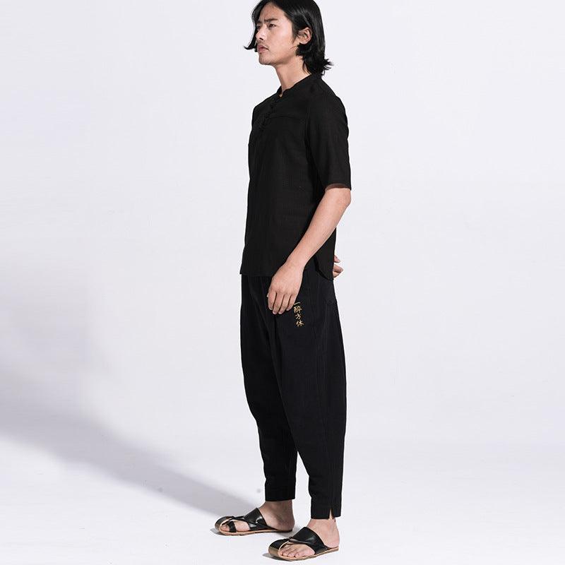 Men's black loose casual pants with elastic waistband, drawstring, tapered ankle