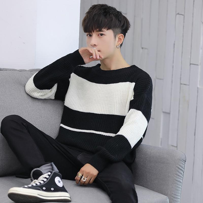 Black crewneck knit sweater with wide white horizontal stripes and striped sleeves