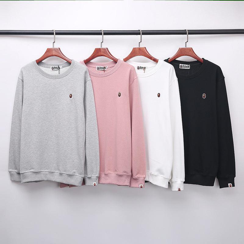 Round-neck chest-embroidered sweater set on hangers: grey, pink, white, black.