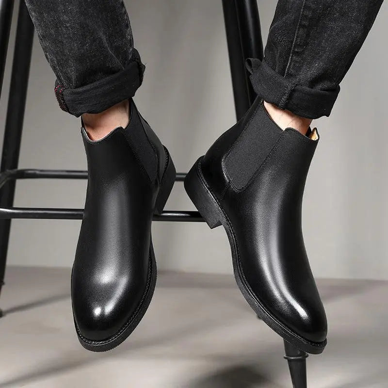 Black high-top Chelsea boots with elastic side panels and low-profile sole