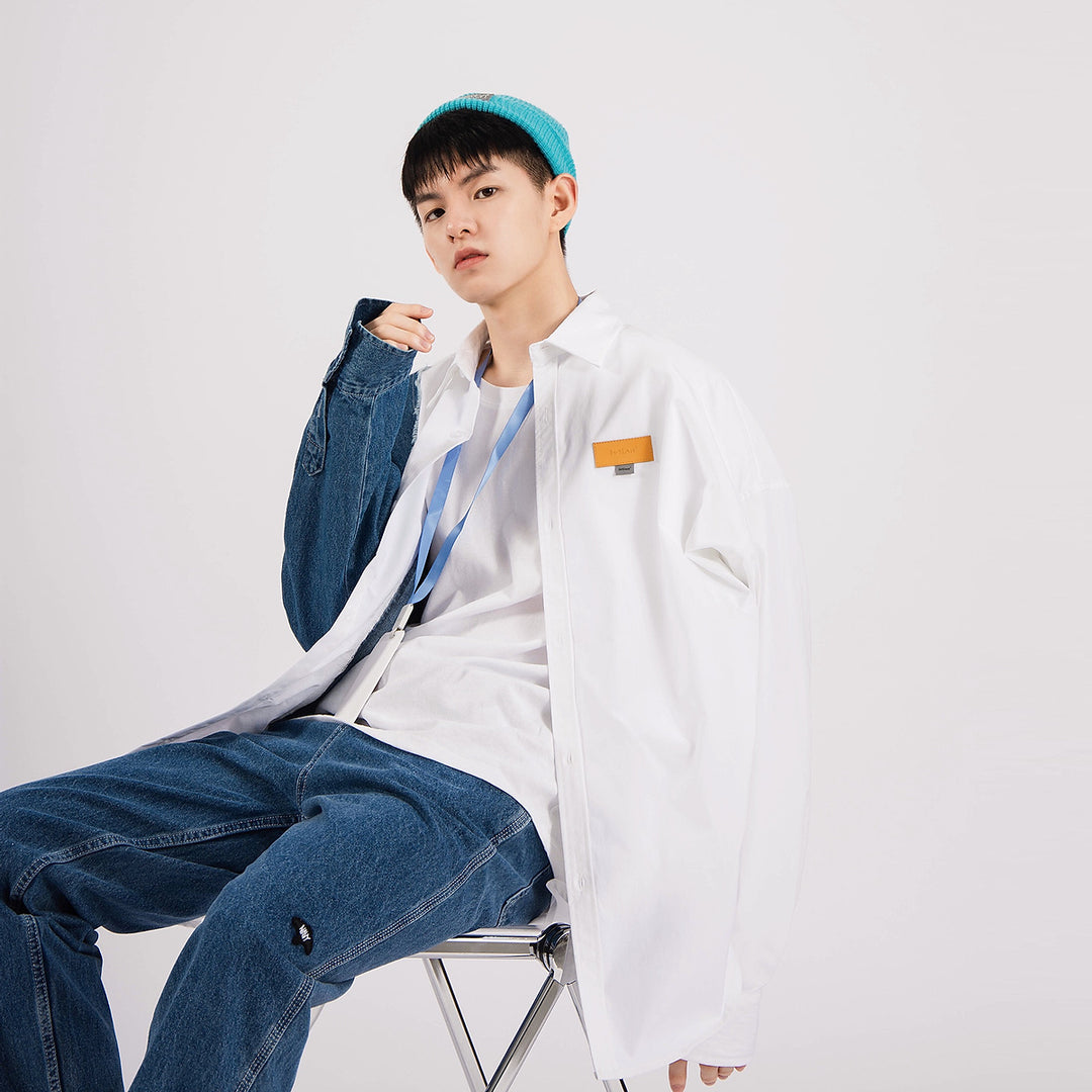 Men's white button-up shirt with orange rectangular chest logo patch
