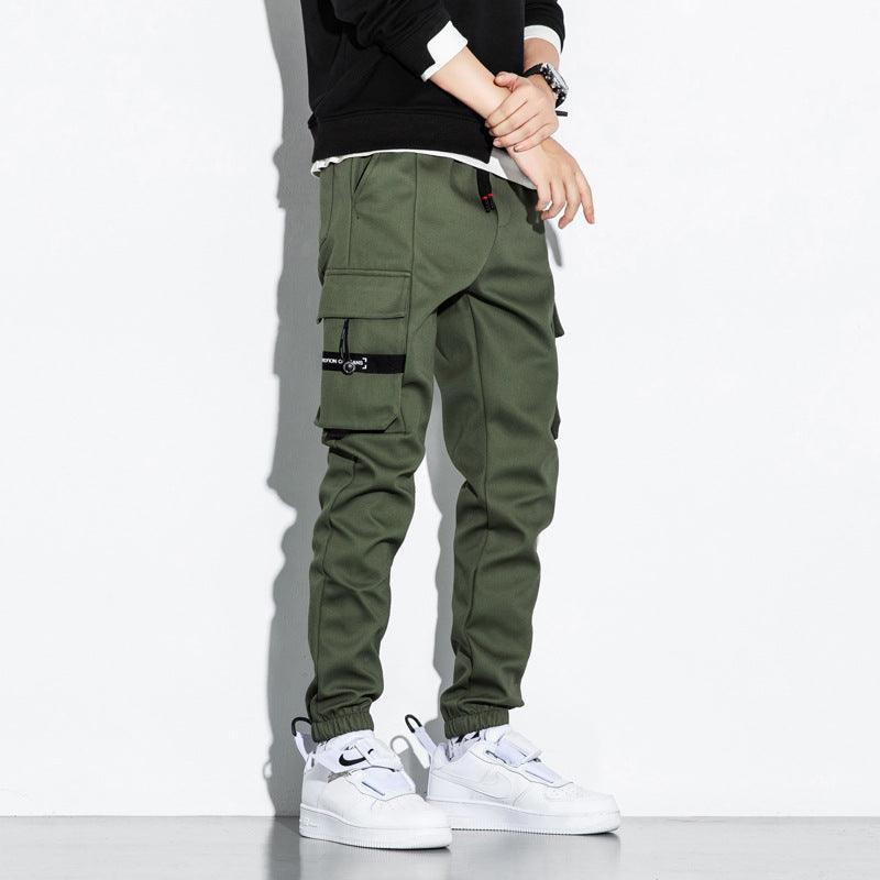 Green cargo trousers with drawstring cuffs and side utility pockets, front view