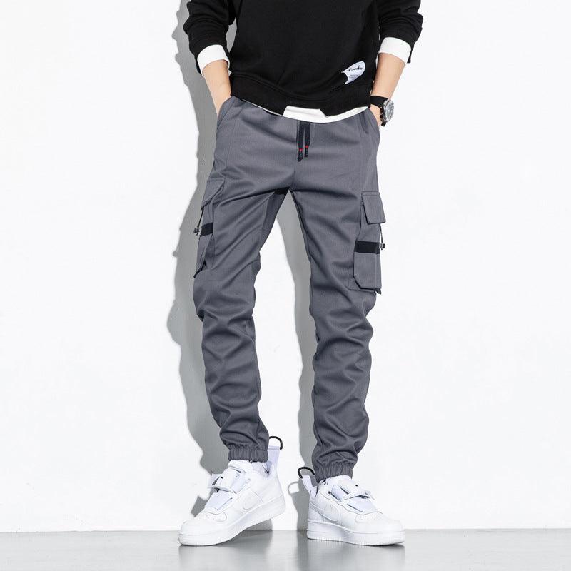 Grey cargo trousers with drawstring cuffs and side utility pockets, front view