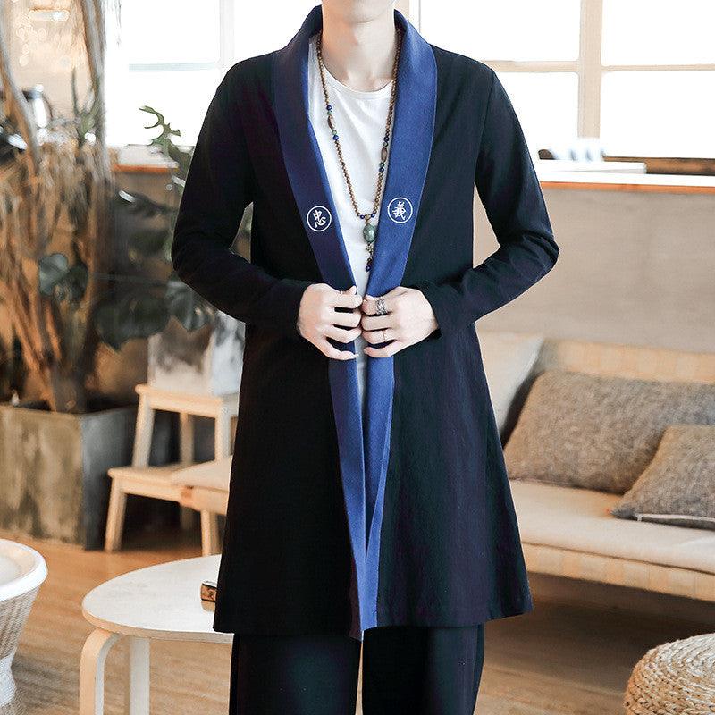 Embroidered trench coat jacket in black with blue lapel trim and round front patches