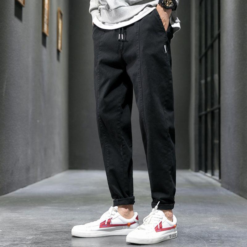 Black jogger-style casual pants with elastic ankle cuffs and drawstring waist