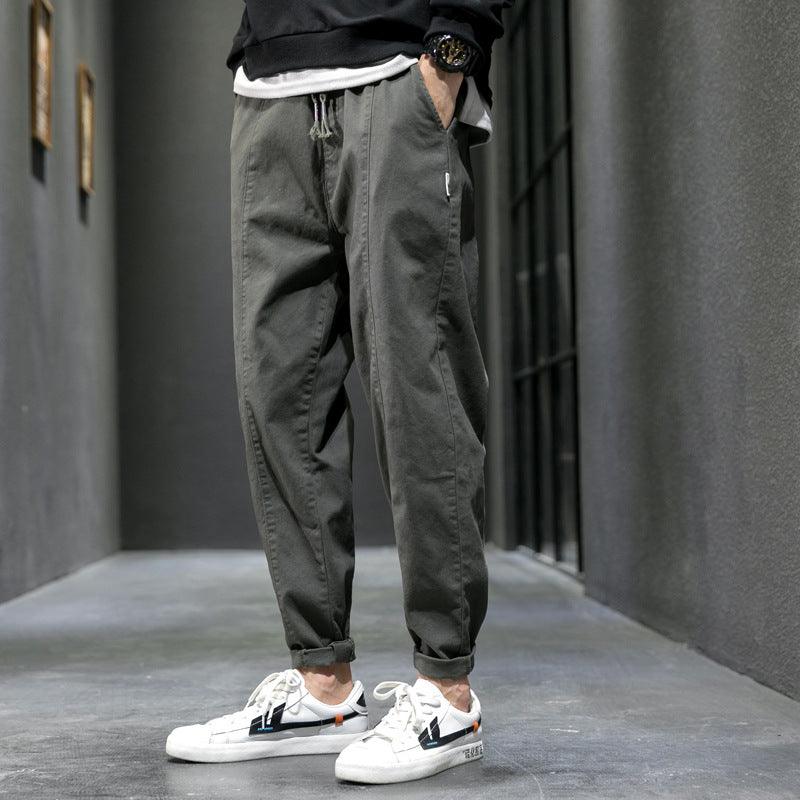 Gray-green jogger pants with drawstring waist and tapered elastic cuffs