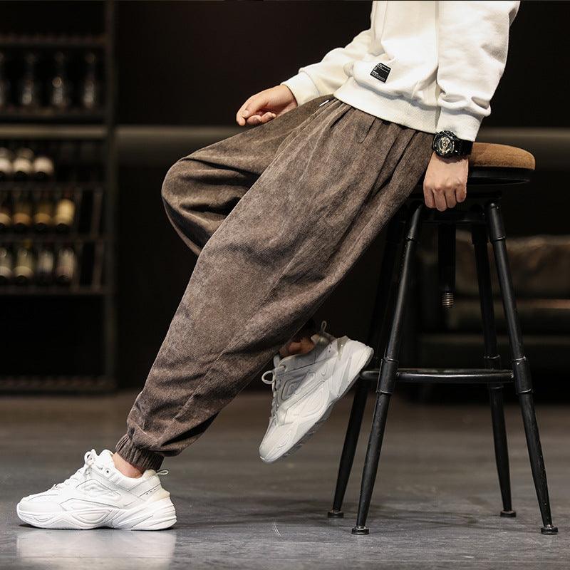 Brown corduroy jogger-style trousers with elastic cuffs and drawstring waist